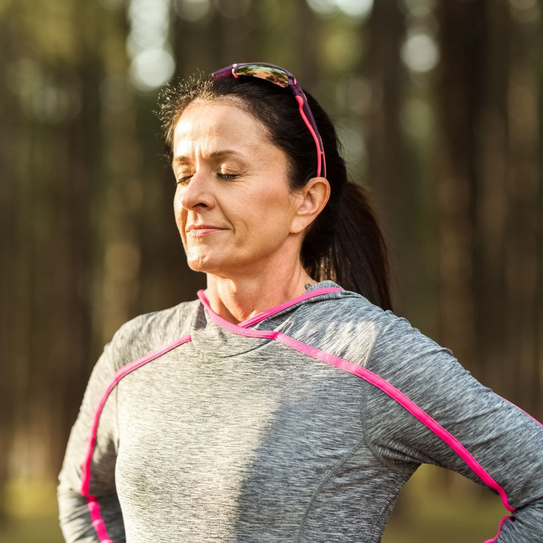 img of a woman taking a deep breath outsite