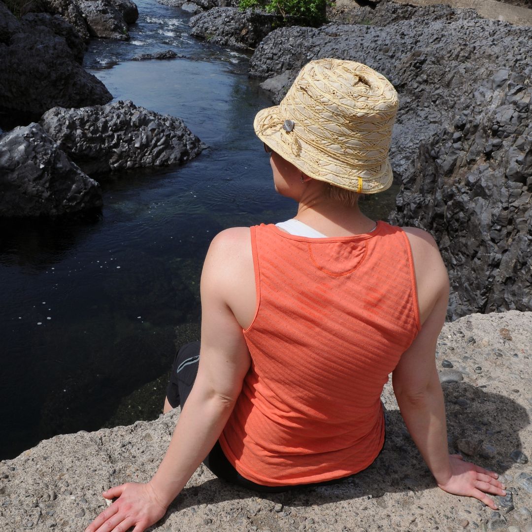 img of someone sitting by a river