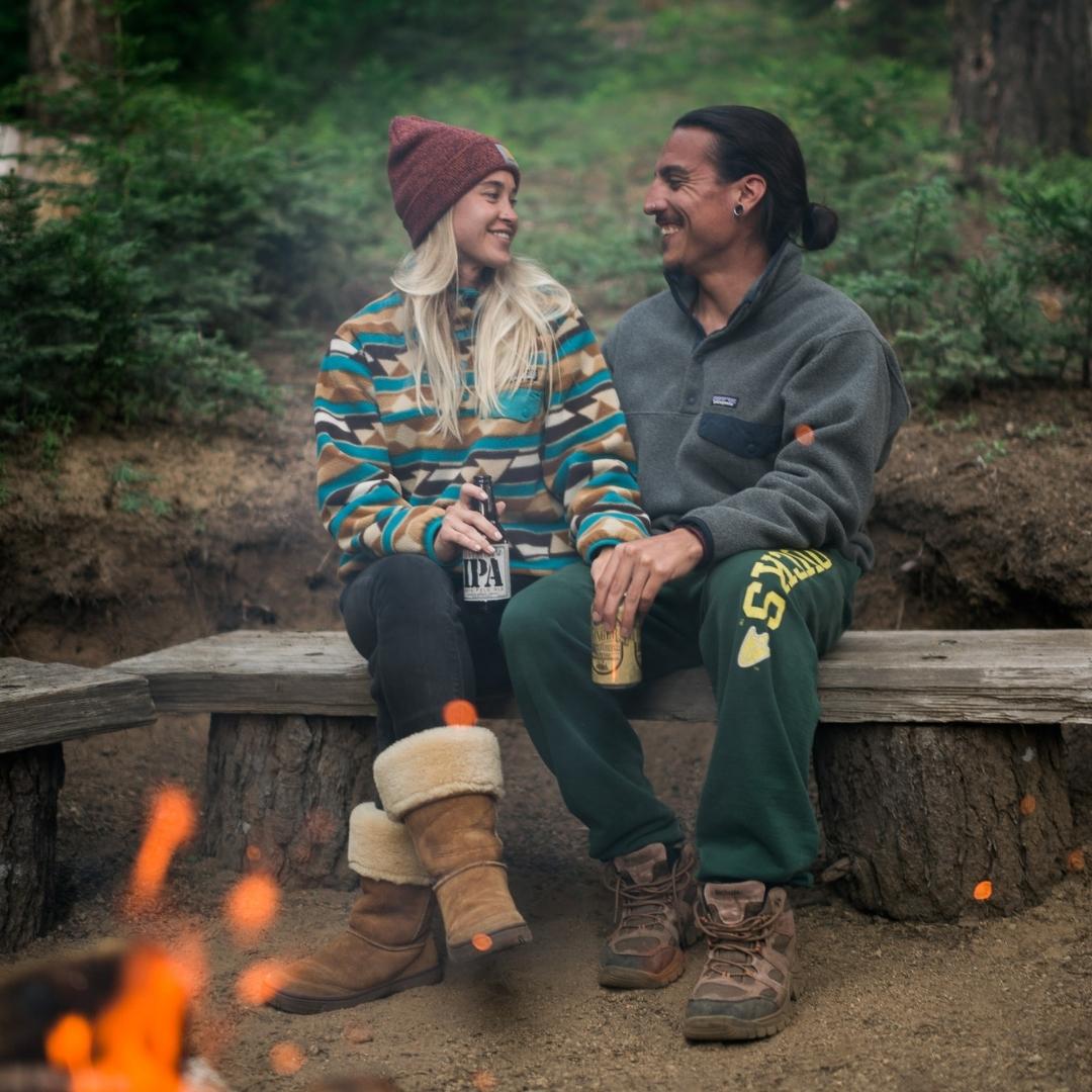 Couple enjoying beer by the fire