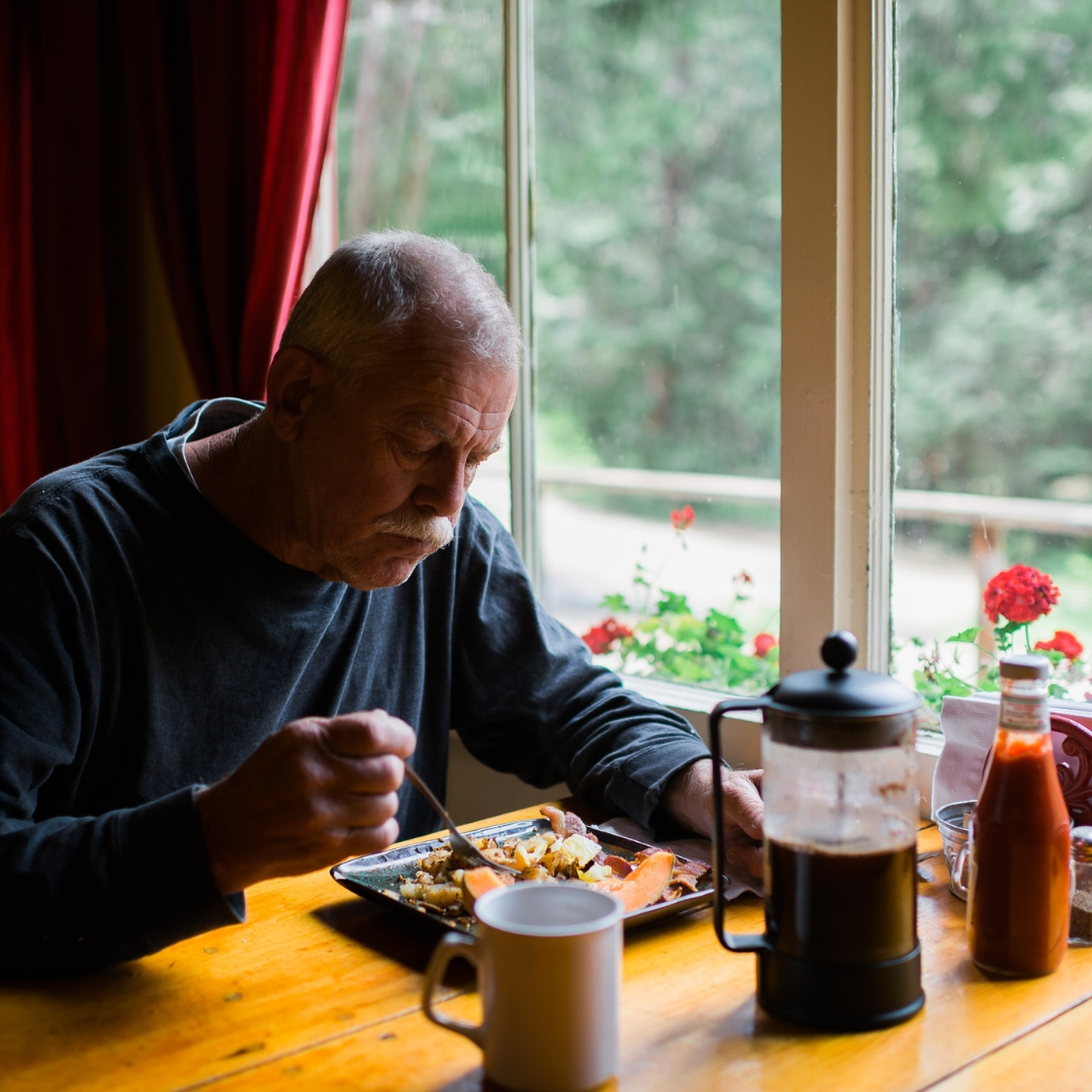 Man eating at onsite restaurant and bar, Silver City Restaurant